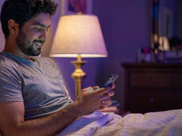 999JILI adult using a smartphone while resting at home