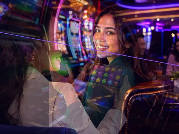 999JILI adults looking at a tablet in a casino-themed scene